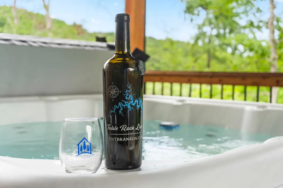 An inviting hot tub with a glass of wine and scenic views through large windows, evoking relaxation and post-adventure unwinding. The tranquil setting promises comfort and connection after a day of excitement.